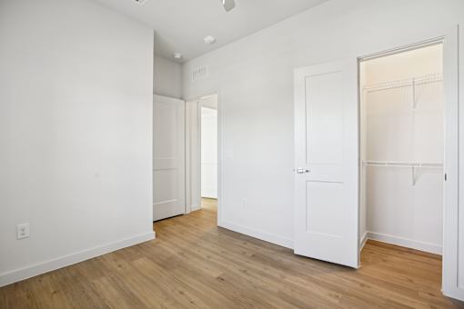 Spacious bedroom with walk-in closet and wood floors at Matador Apartments, Texas, 78745