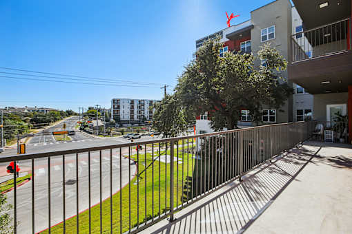 Balcony overlooking green space and street intersection at Matador Apartments, Austin, 78745