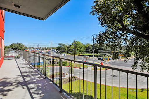Balcony view of busy street and trees at Matador Apartments, Austin, Texas