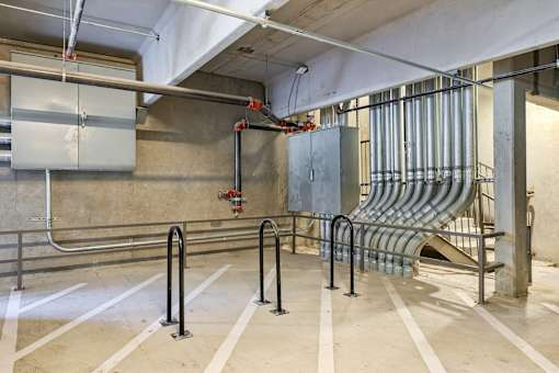 A parking garage with a ramp and a fire extinguisher.