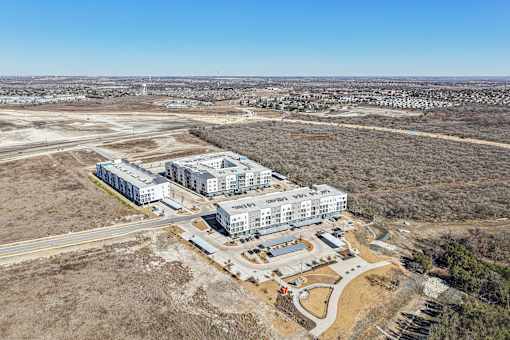A large building complex is under construction in a barren landscape. at ThreeTwenty at the Vybe Apartments, Texas