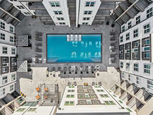 Aerial view of courtyard pool with lounge seating at Matador Apartments, Austin, TX