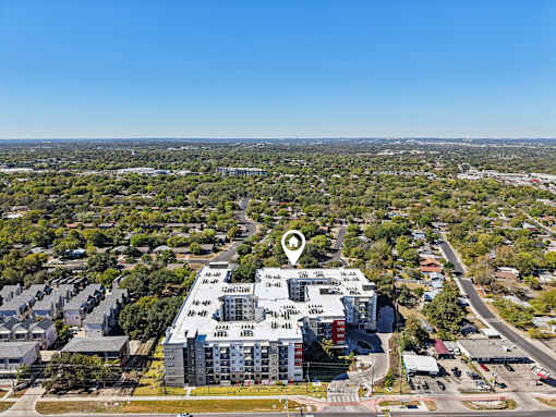 Aerial view of modern apartment complex with rooftop amenities at Matador Apartments, Austin, Texas