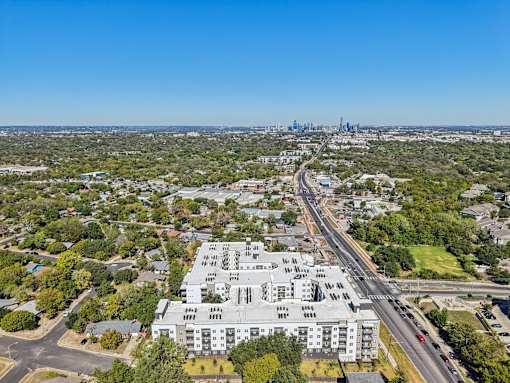 Aerial view of apartment building and downtown skyline at Matador Apartments, Texas
