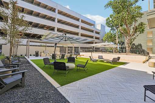 A patio area with a white building in the background.