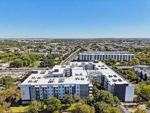 Aerial view of modern apartment rooftops and surrounding area at Matador Apartments, Austin, TX 78745