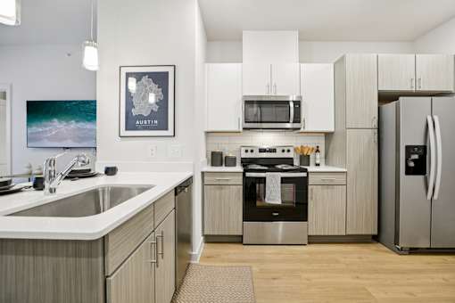 Kitchen with white countertops and stainless steel range at Matador Apartments, Austin, 78745