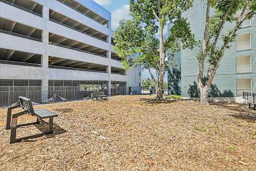 A parking garage with a bench in front of it.