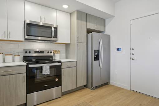 A modern kitchen with a stainless steel refrigerator and oven. at Park South Apartments, Texas