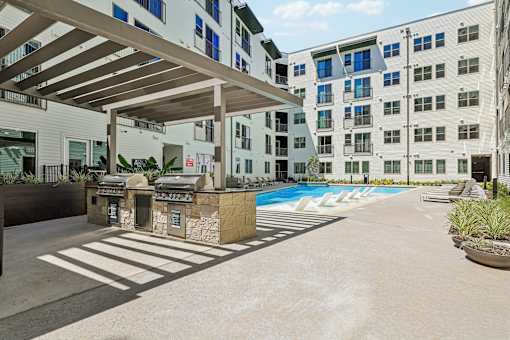 A modern building with a pool and a covered walkway.