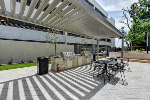 A patio with a table and chairs under a white awning.