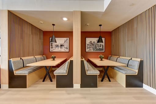 A modern dining room with a long table and chairs.