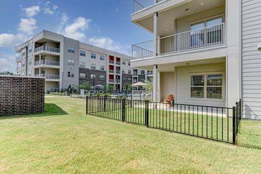 Ground floor patio with private fenced yard at Cantarra Apartments, Manor, TX 78653