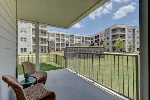 Covered patio with courtyard view and seating at Cantarra Apartments, Manor, 78653