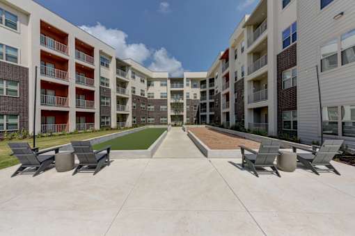 Central courtyard with seating and walkway at Cantarra Apartments, Manor
