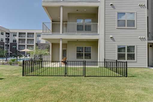 Two story townhome with balcony and fenced patio at Cantarra Apartments, Manor, Texas