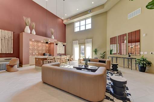Clubhouse lounge with high ceilings and kitchen at Cantarra Apartments, Manor