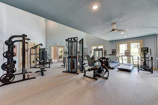 Fitness center with weight equipment and cardio machines at Cantarra Apartments, Texas, 78653