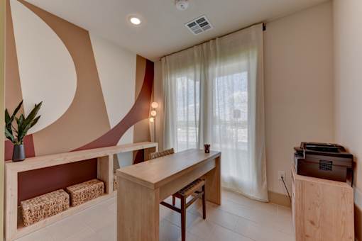 Private office with desk and natural light at Cantarra Apartments, Manor, Texas
