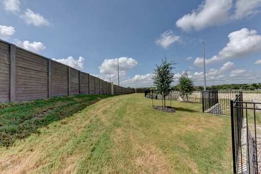Property perimeter with fencing and landscaped pathway at Cantarra Apartments, Manor