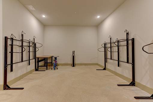 Indoor fitness storage room with wall mounted racks at Cantarra Apartments, Texas, 78653