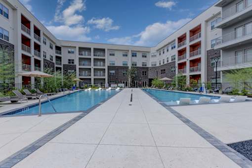 Resort style pool courtyard with split design at Cantarra Apartments, Texas