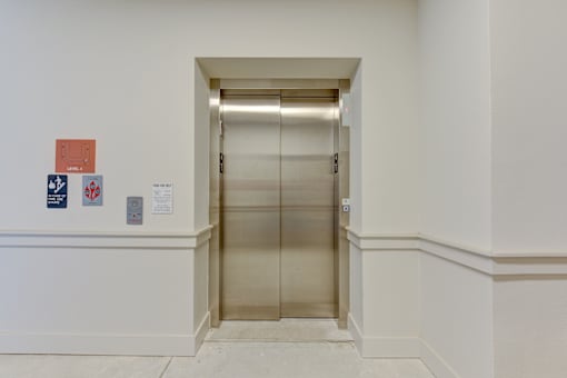 Elevator lobby with stainless steel doors at Cantarra Apartments, Manor