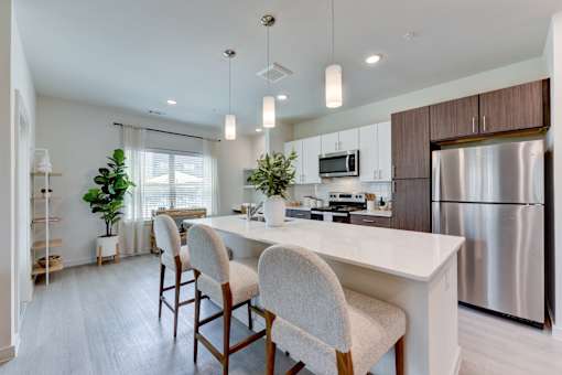 Open concept kitchen with island seating at Cantarra Apartments, Manor, 78653