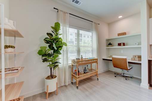 Home office nook with floating desk and bar cart at Cantarra Apartments, Manor, Texas