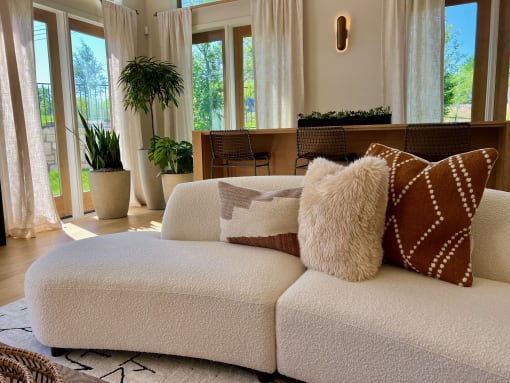 a white couch with brown and white pillows in a living room at Delco Flats, Austin, Texas