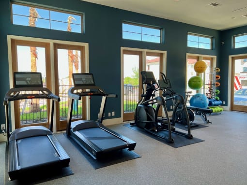 a gym with treadmills and other exercise at Delco Flats, Austin Texas