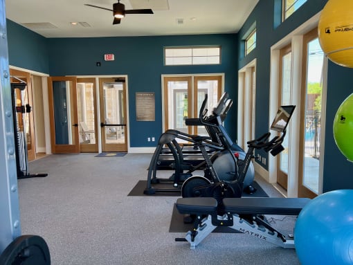 a gym with cardio equipment and weights at Delco Flats, Austin, Texas