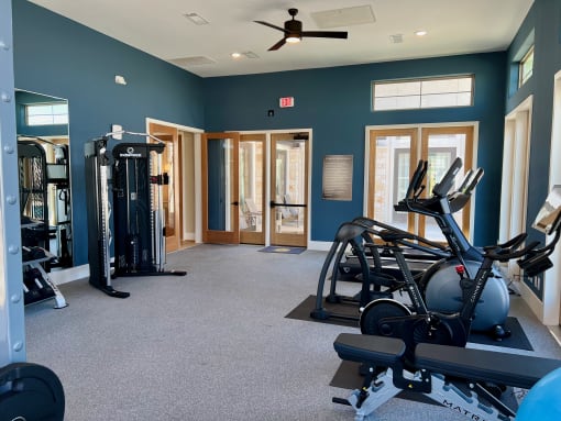 a gym with exercise equipment and a ceiling fan at Delco Flats, Austin, 78717