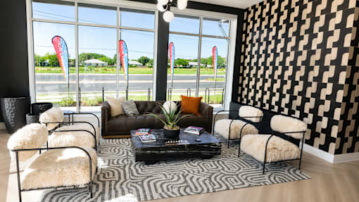 A black and white patterned wall in a room with a table and chairs.