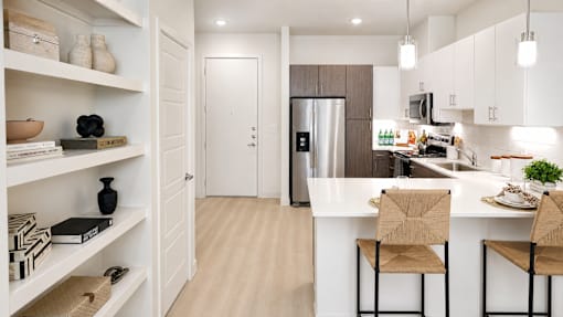 A kitchen with a white counter and a refrigerator.