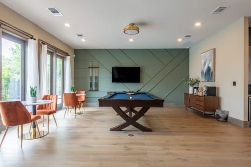 Pool table and TV in the clubhouse at Bridge at Paloma Affordable Apartments 78754 Northeast Austin