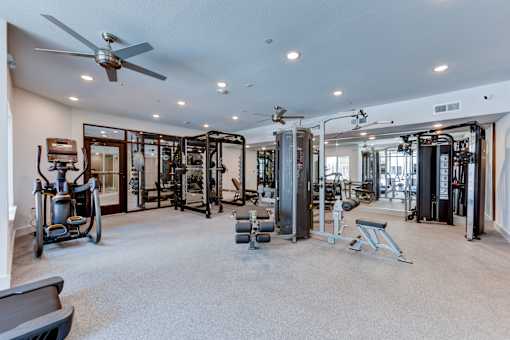 A spacious home gym with a variety of exercise equipment.