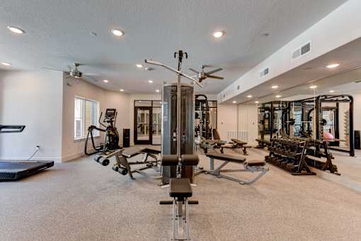 A spacious home gym with a variety of equipment.