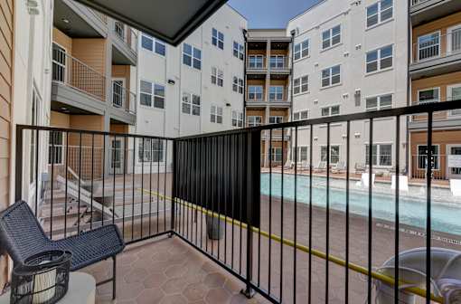 A black metal fence surrounds a pool area.