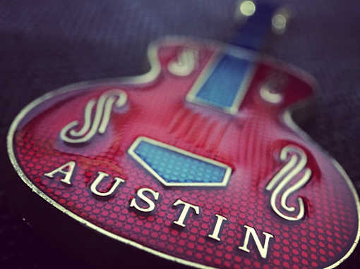 A guitar pick with the word Austin on it.