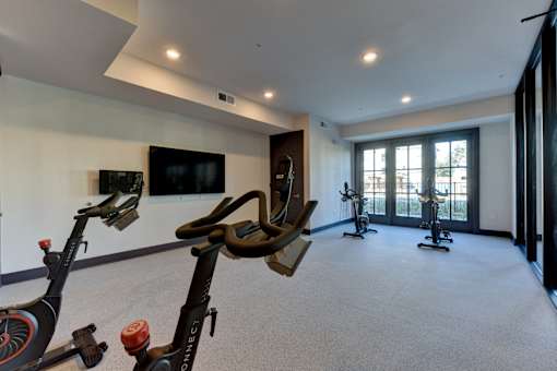 A room with exercise equipment and a flat screen TV.