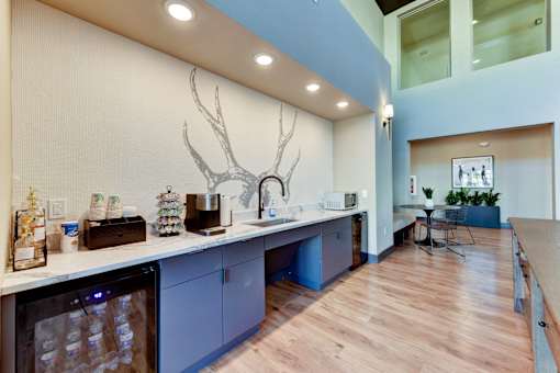 A kitchen with a deer head mounted on the wall.