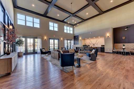 A spacious living room with wooden floors and furniture.