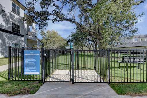A gate with a sign on it in front of a building.