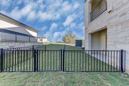 A black metal fence in front of a house.