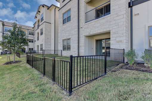 A black metal fence in front of a building.