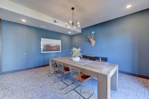 A dining room with a wooden table and chairs.