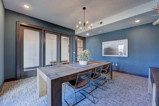 A dining room with a wooden table and chairs.