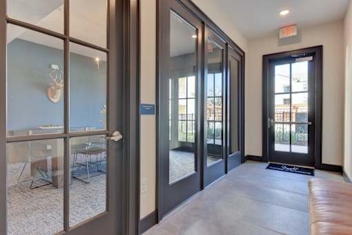 A room with a glass door leading to a balcony.