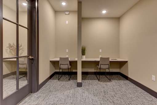 A room with a table and chairs and a plant.